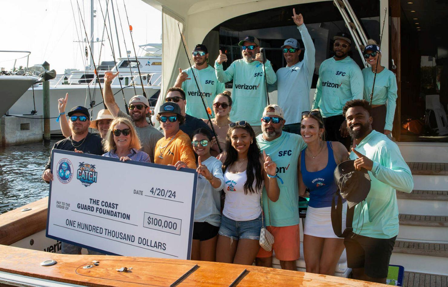 A group of people celebrate on the back of a fishing boat.