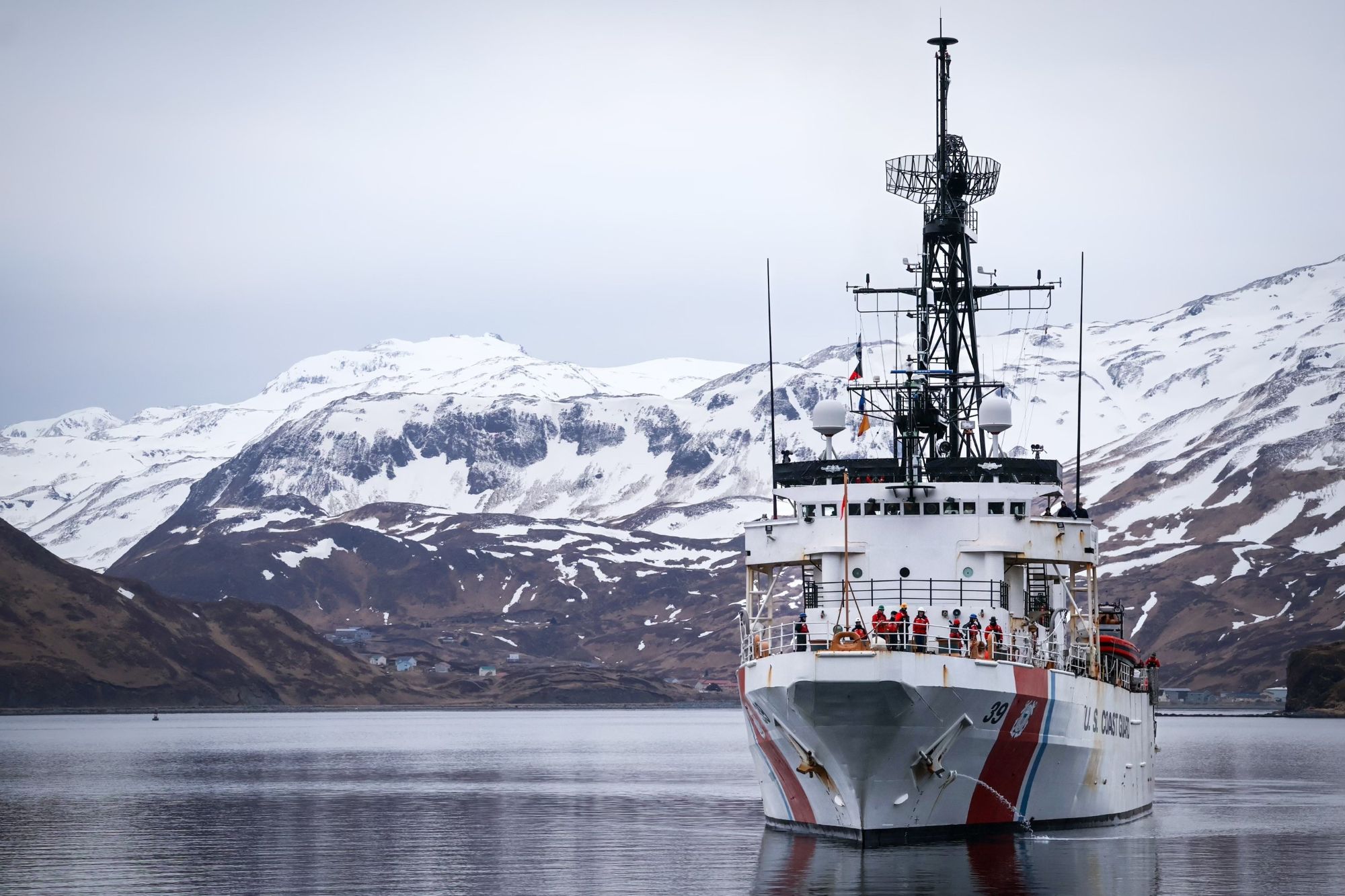 Ship in front of a mountainous landscape