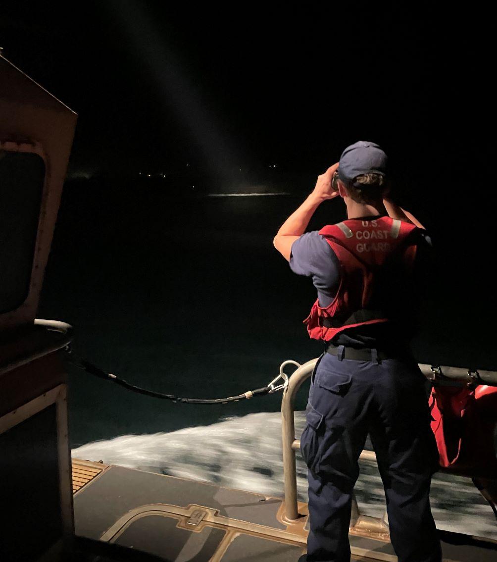 A man searching with binoculars.