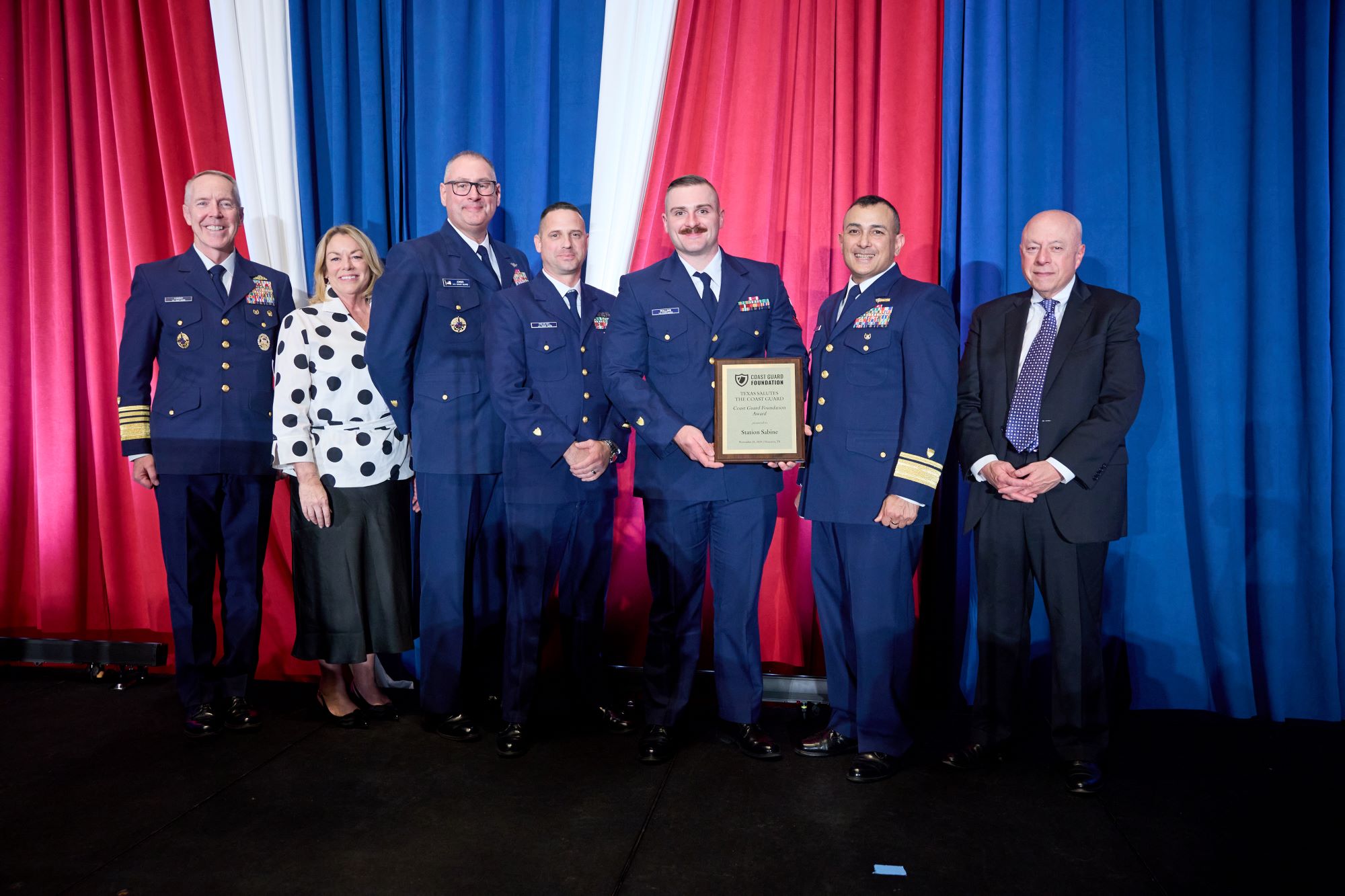 A group standing on a stage