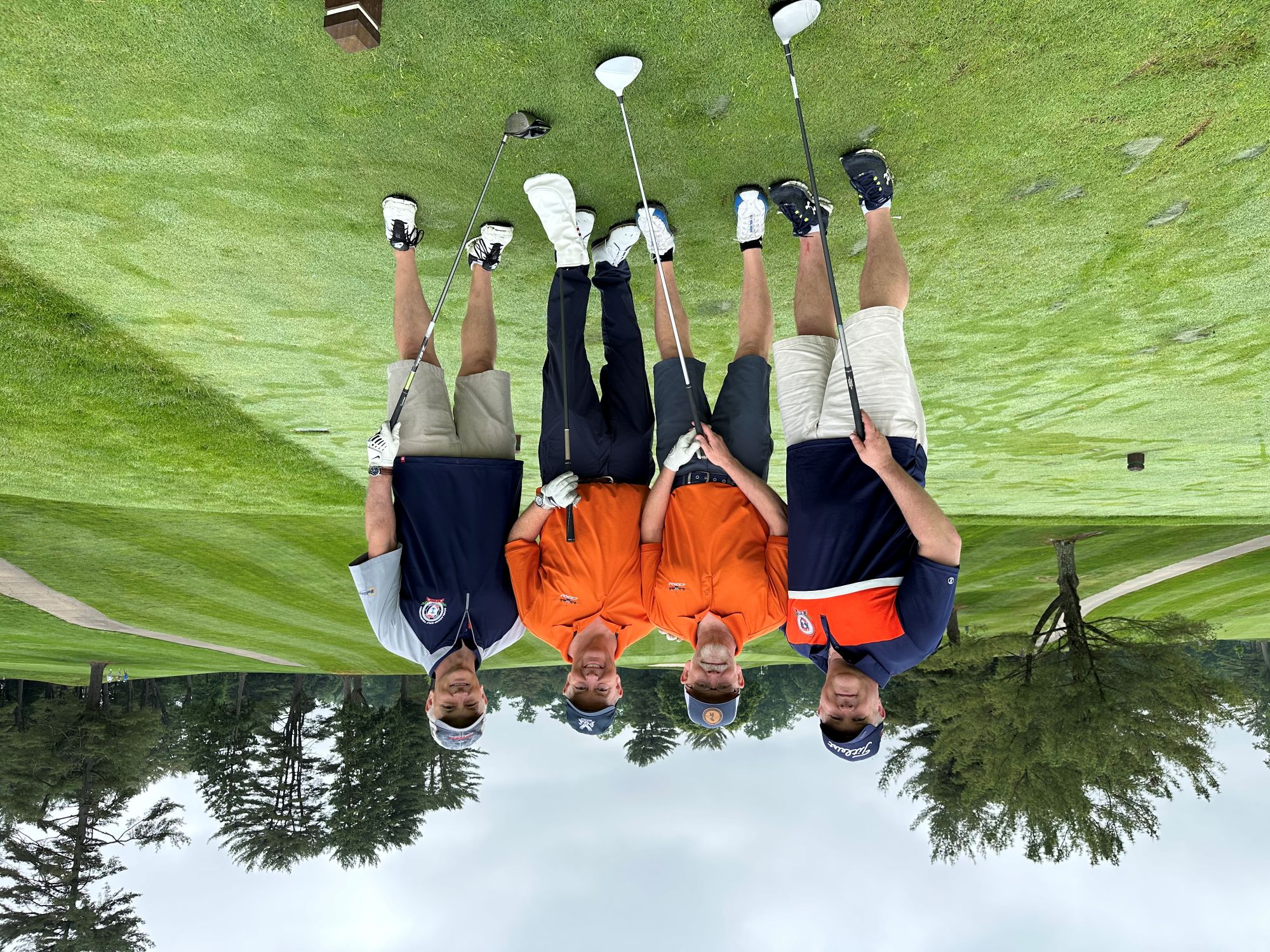 four golfers pose for a picture