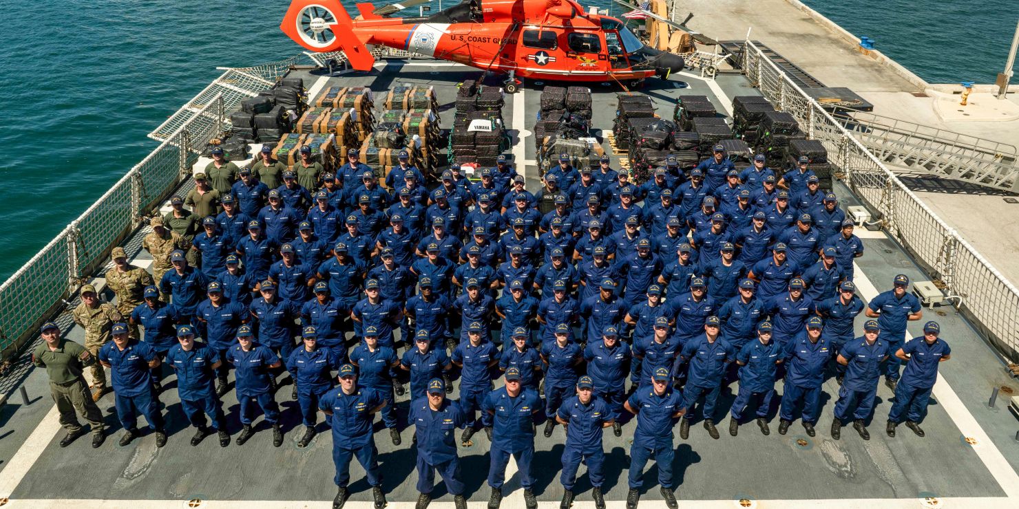 Coast Guard members and helicopter